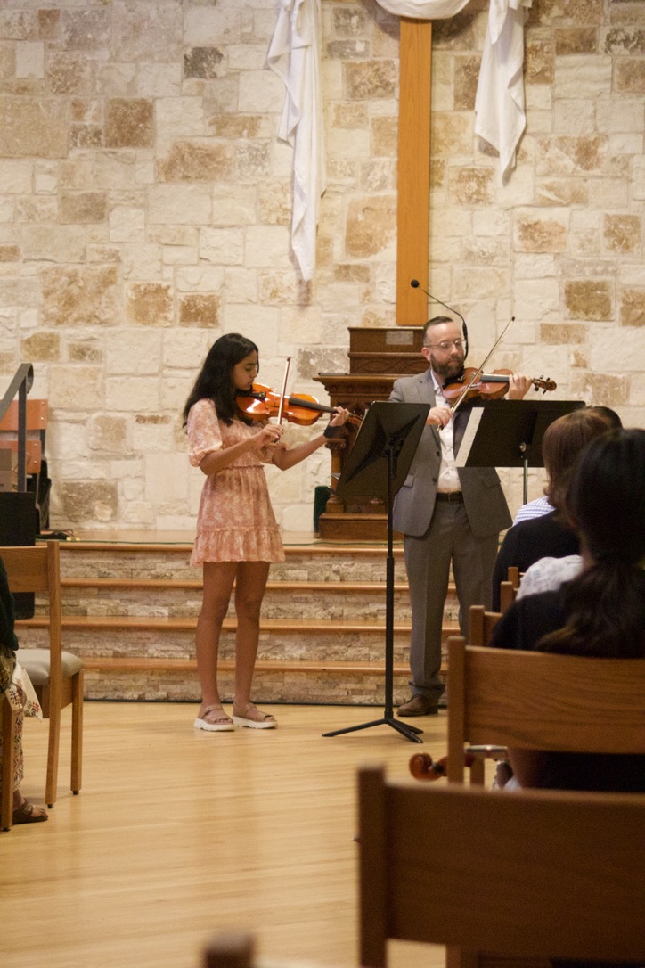 Violin student performing a duet with David Price at a studio recital
