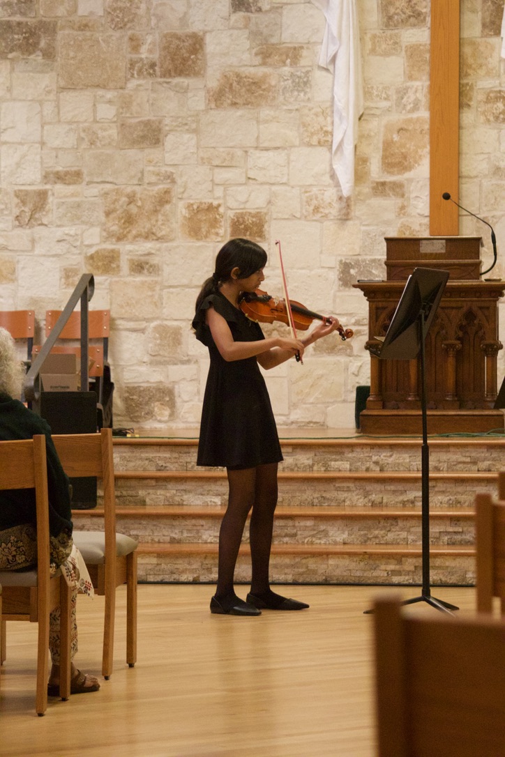Violin student performing solo at a studio recital